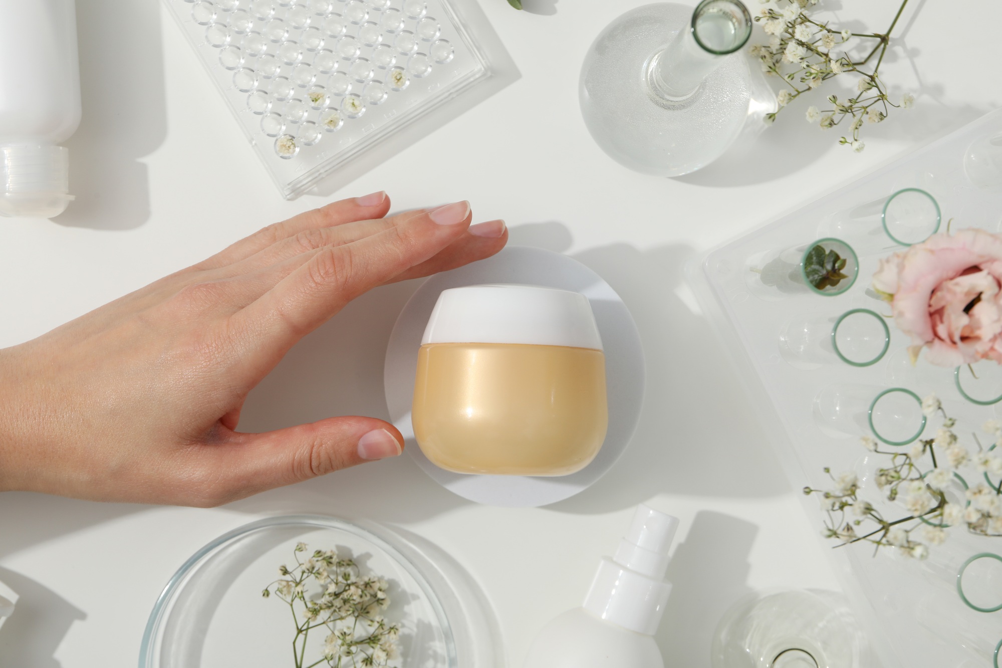 Cosmetics with chemical test tubes and flowers